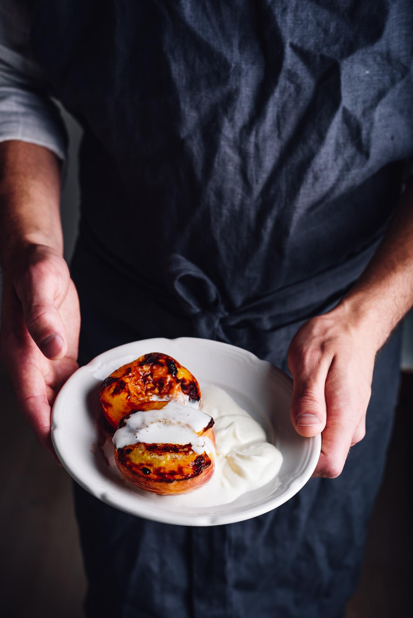 Chef arranging modern plated dish in studio